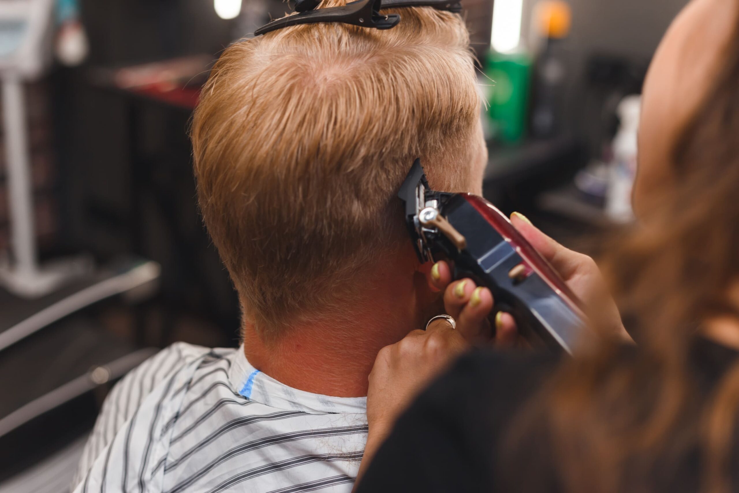 female-barber-in-mask-cuts-a-man-hairs-with-hair-c-2025-02-13-02-00-12-utc (1) (1)
